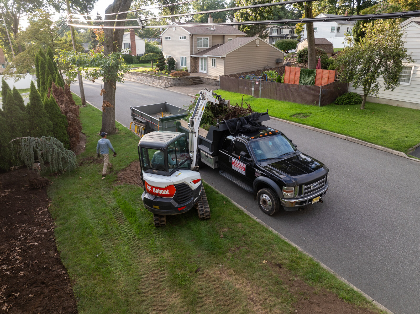 Aerial view of Angelscape job site with Bobcat excavator and company truck